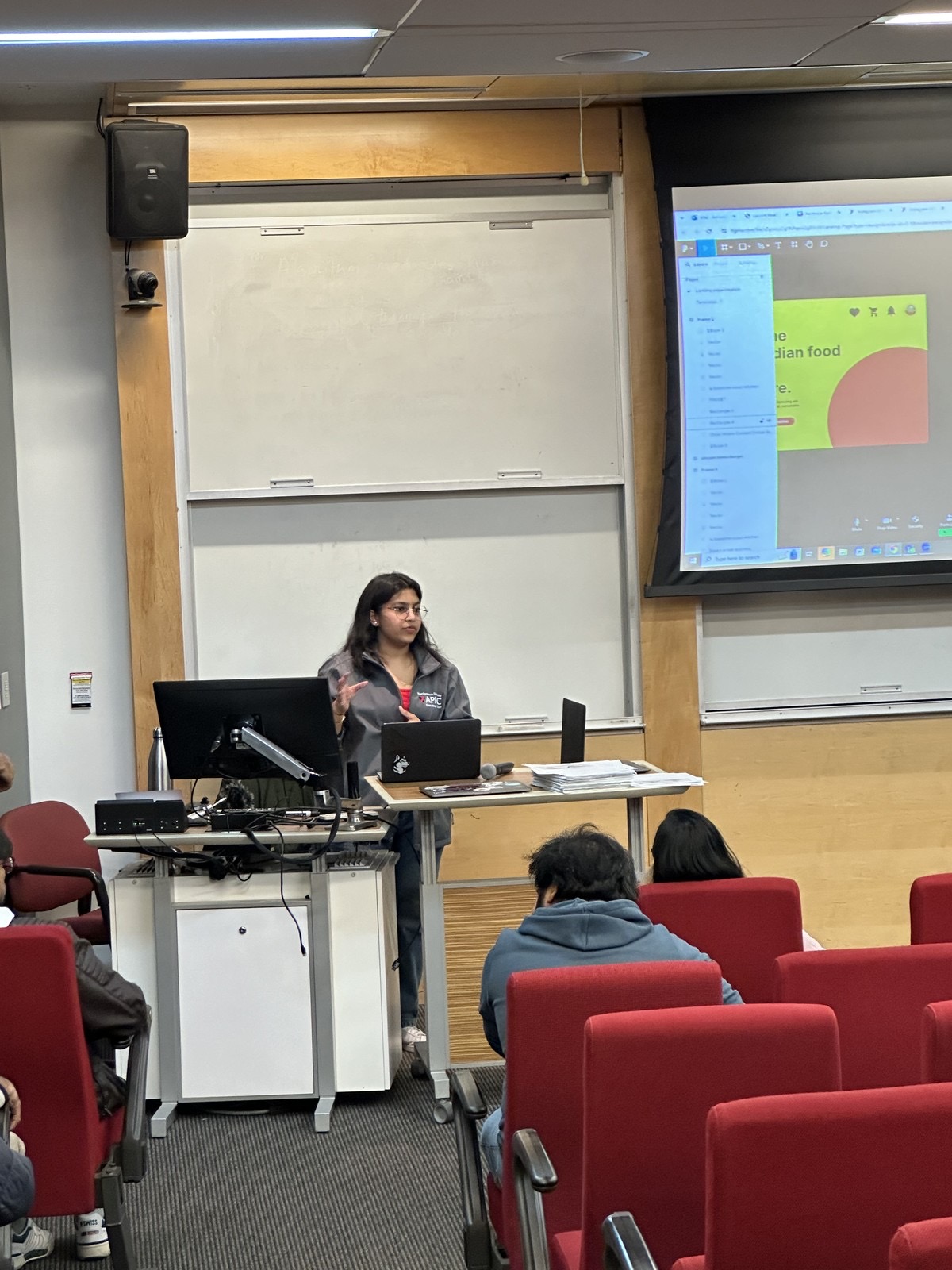 Pinkle presenting at a lectern