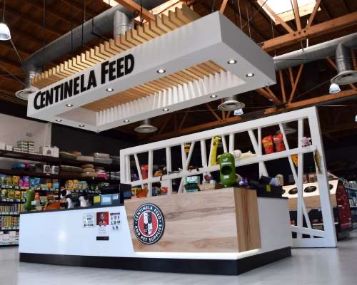Inside a Centinela Feed store: the checkout counter under a Centinela Feed sign